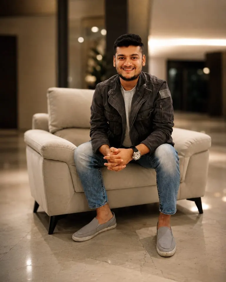 Burhan Kapasi, founder of Mago Labs, sitting on an armchair and smiling